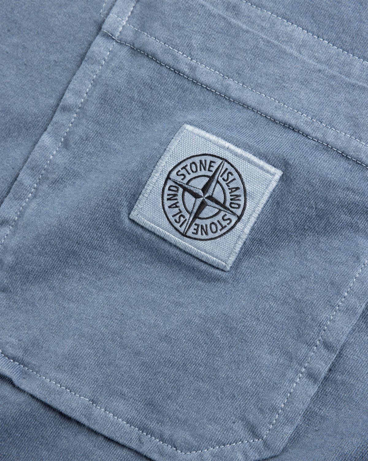 Stone island badge on sale shirt